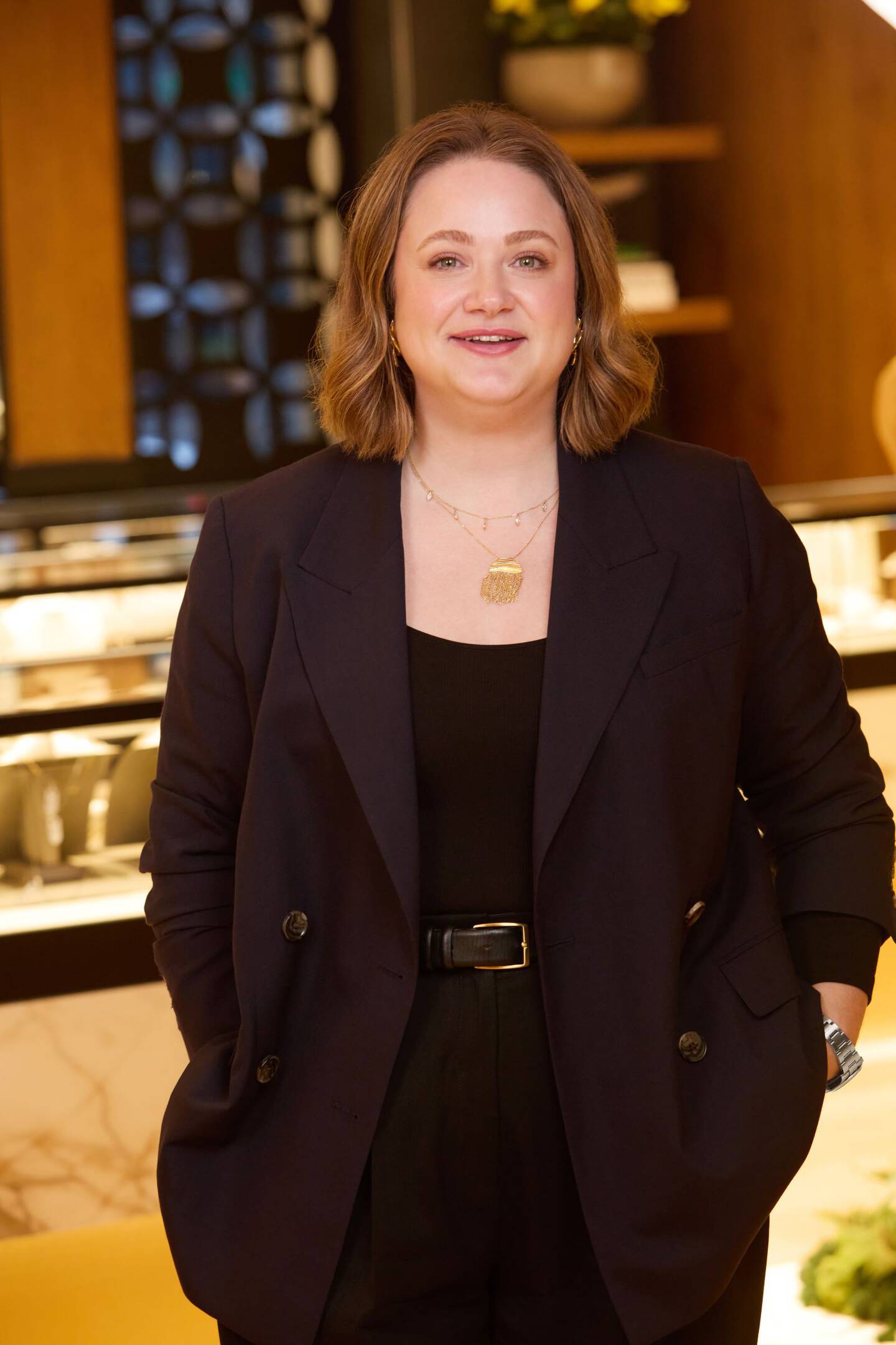 Angela Hope standing with hands in pockets inside Ben Bridge store. 